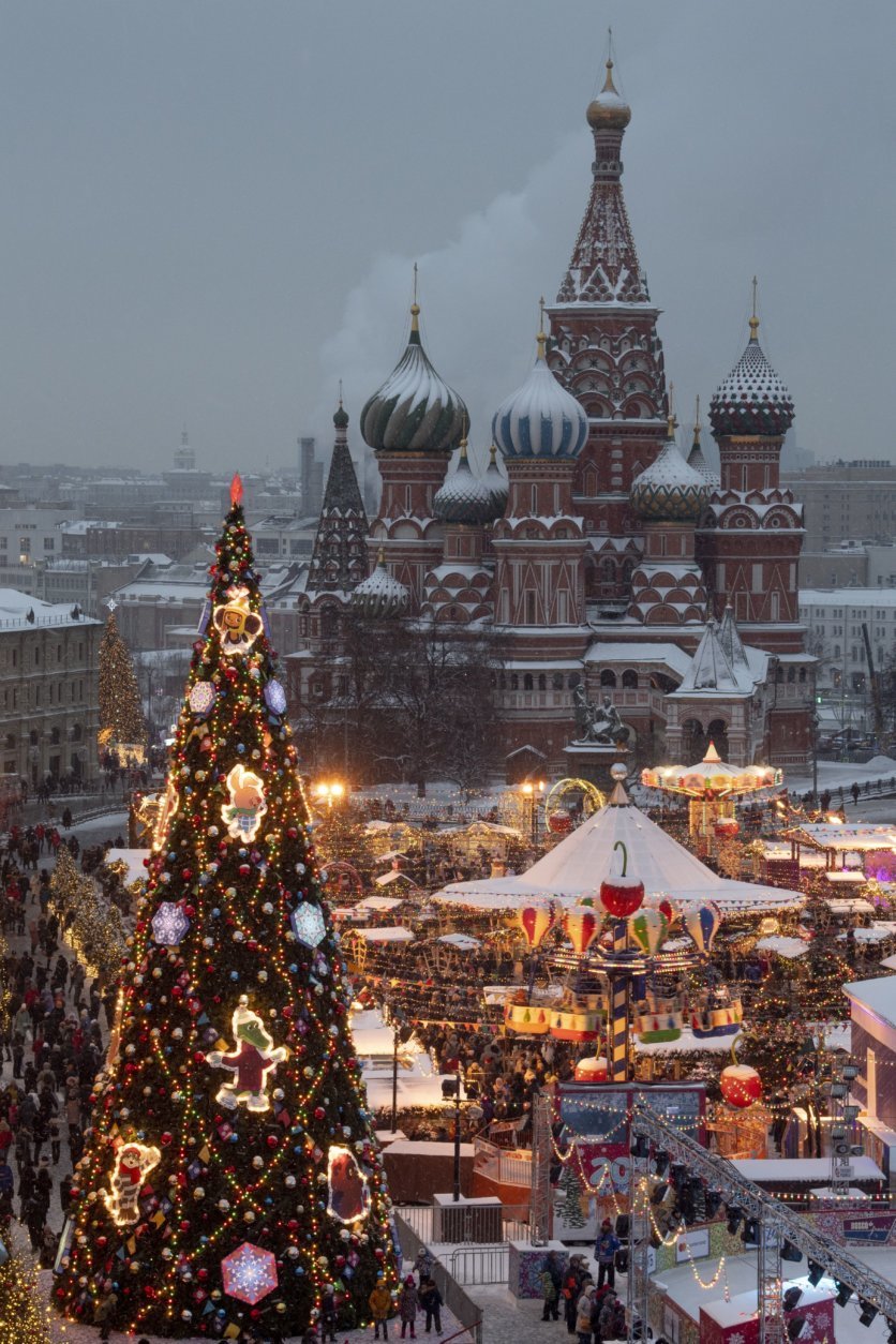 Red Square decorated for New Year celebrations is seen from a roof of the Moscow GUM State Department store with a Christmas market and the St. Basil's Cathedral in the background in Moscow, Russia, Saturday, Dec. 22, 2018. (AP Photo/Alexander Zemlianichenko, Pool)