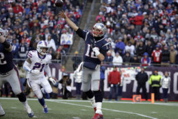 New England Patriots quarterback Tom Brady (12) passes under pressure from Buffalo Bills safety Jordan Poyer (21) during the second half of an NFL football game, Sunday, Dec. 23, 2018, in Foxborough, Mass. (AP Photo/Steven Senne)