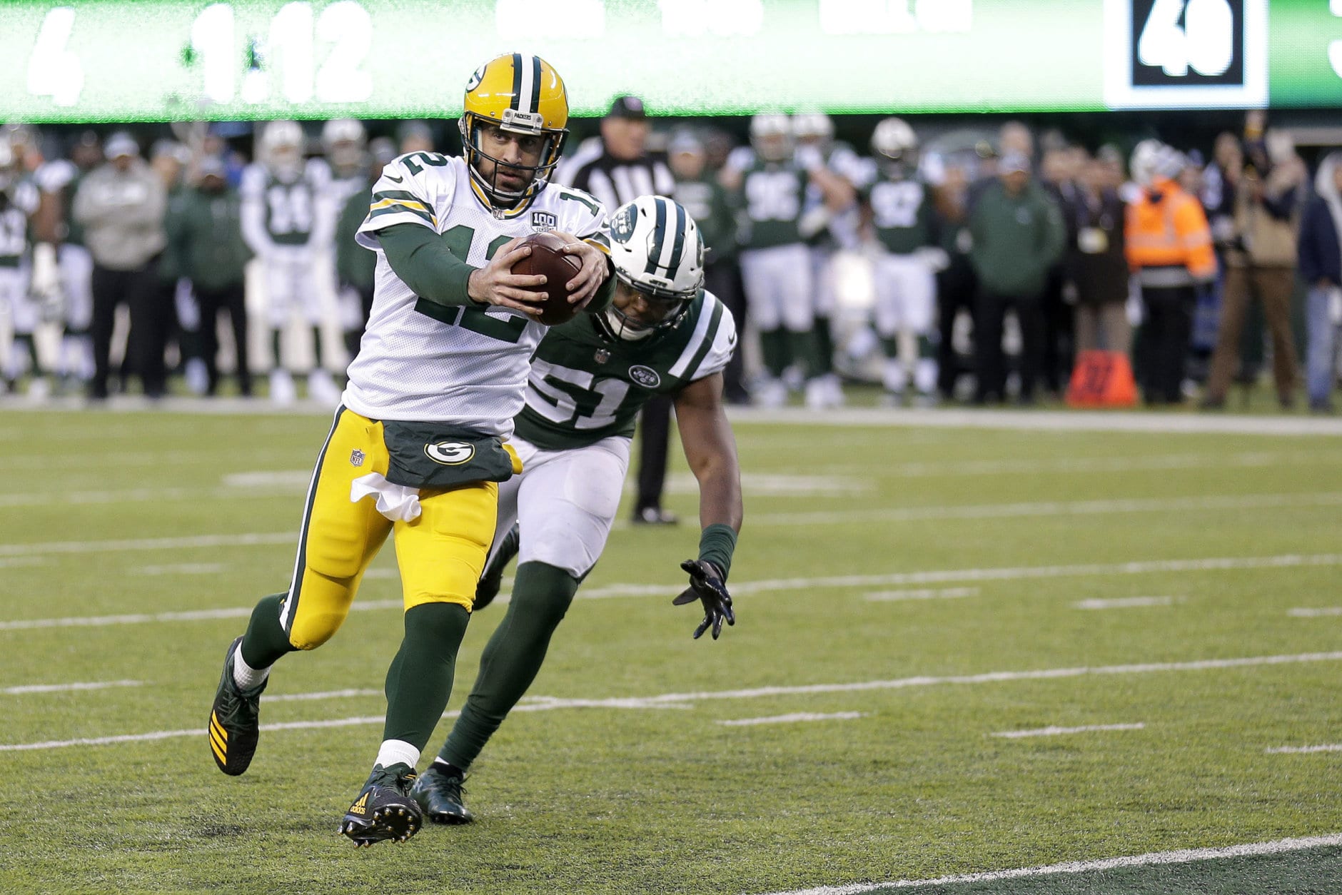 Green Bay Packers quarterback Aaron Rodgers, front, scores a two-point conversion as New York Jets outside linebacker Brandon Copeland chases him during the second half of an NFL football game, Sunday, Dec. 23, 2018, in East Rutherford, N.J. (AP Photo/Seth Wenig)