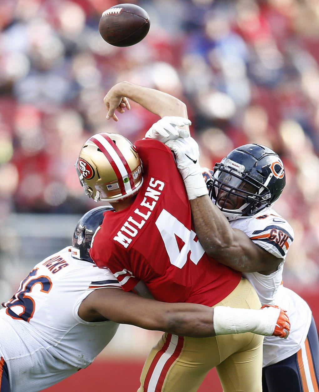 San Francisco 49ers quarterback Nick Mullens (4) is hit by Chicago Bears defensive end Akiem Hicks, left, and outside linebacker Khalil Mack during the second half of an NFL football game in Santa Clara, Calif., Sunday, Dec. 23, 2018. (AP Photo/D. Ross Cameron)