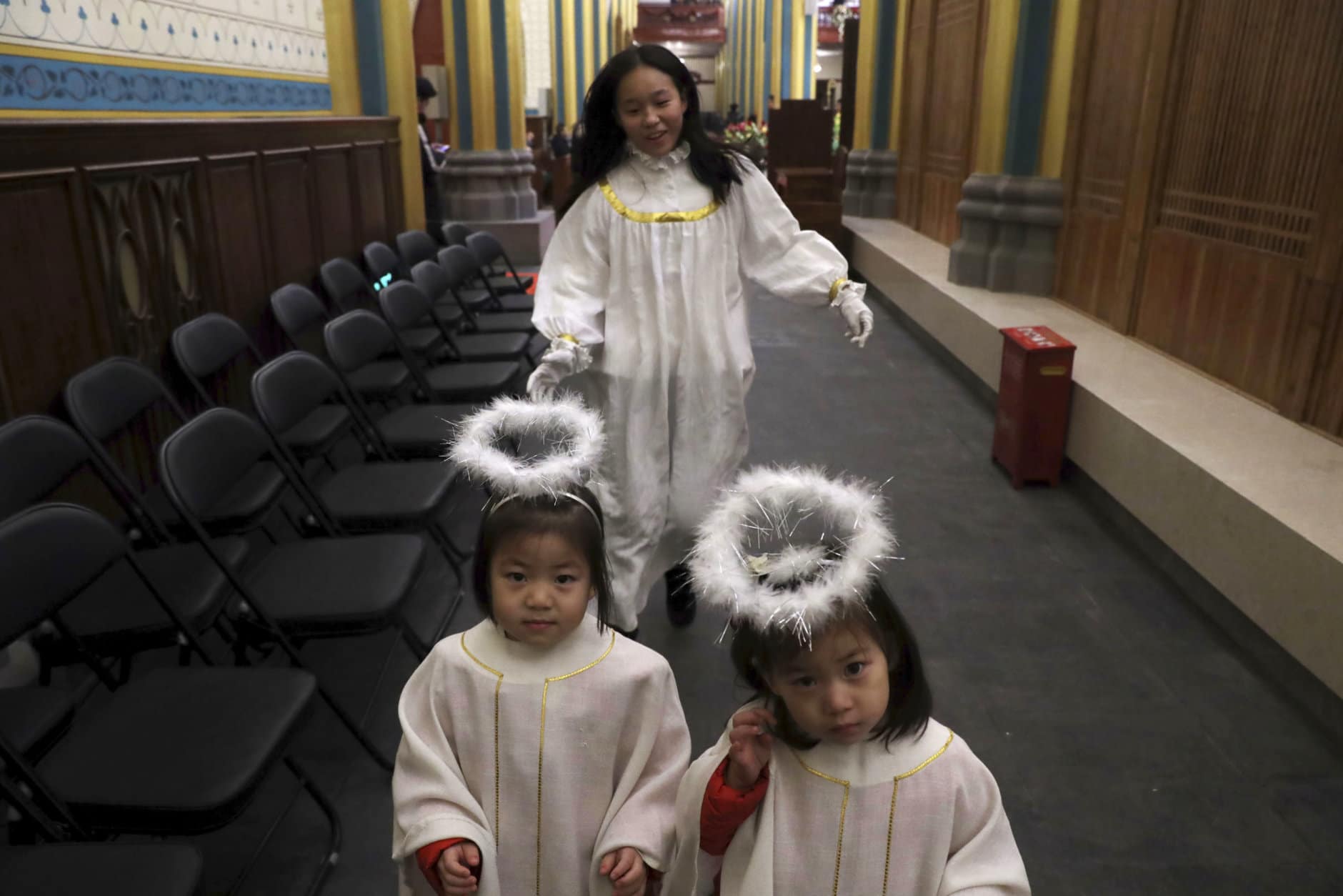 Young girls dressed as angels rehearse for the Christmas Eve mass at the Xishiku Catholic Church in Beijing, China, Monday, Dec. 24, 2018. (AP Photo/Ng Han Guan)