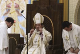 Chinese Bishop Joseph Li Shan, center leads the Christmas Eve mass at the Xishiku Catholic Church in Beijing, China, Monday, Dec. 24, 2018. (AP Photo/Ng Han Guan)