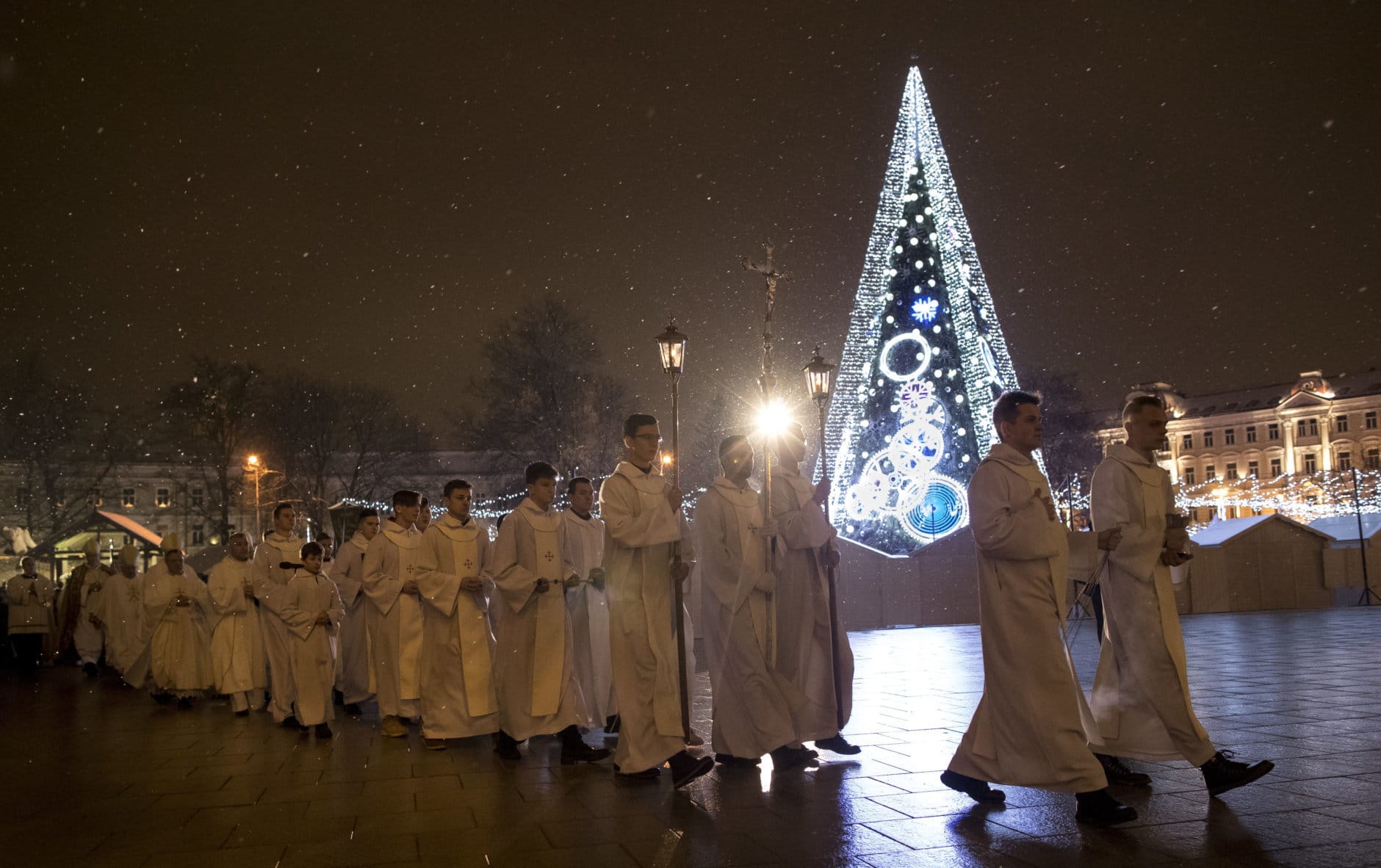 Priests and clergy process to attend the Christmas celebration midnight Mass at the Cathedral-Basilical in Vilnius, Lithuania, Monday, Dec. 24, 2018. Over 80 percent of Lithuanians are Christians who celebrate the festival of Christmas on Dec. 25. (AP Photo/Mindaugas Kulbis)