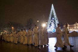 Priests and clergy process to attend the Christmas celebration midnight Mass at the Cathedral-Basilical in Vilnius, Lithuania, Monday, Dec. 24, 2018. Over 80 percent of Lithuanians are Christians who celebrate the festival of Christmas on Dec. 25. (AP Photo/Mindaugas Kulbis)