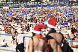 Beachgoers celebrate Christmas at Bondi Beach in Sydney, Tuesday, Dec. 25, 2018. (Mick Tsikas/AAP Image via AP)