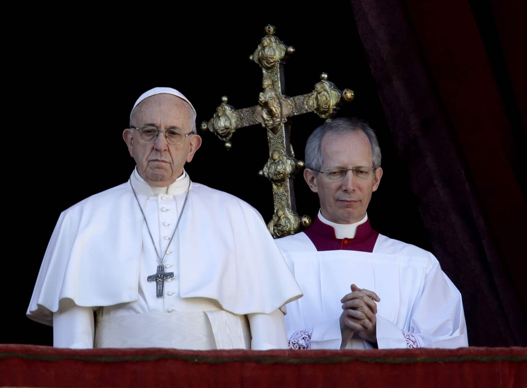 Pope Francis, flanked by Master of Ceremonies Bishop Guido Marini, looks at St. Peter's Square after the Urbi et Orbi (Latin for 'to the city and to the world' ) Christmas' day blessing from the main balcony of St. Peter's Basilica at the Vatican, Tuesday, Dec. 25, 2018. (AP Photo/Alessandra Tarantino)