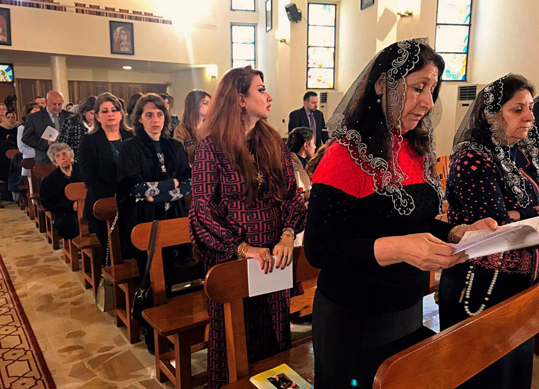Iraqis pray during Christmas Mass at Mar Youssif Chaldean Church, in Baghdad, Iraq, Tuesday, Dec. 25, 2018. Although the number of Christians has dropped in Iraq, Christmas, a national holiday, is very popular in the capital. (AP Photo/Ali Abdul Hassan)