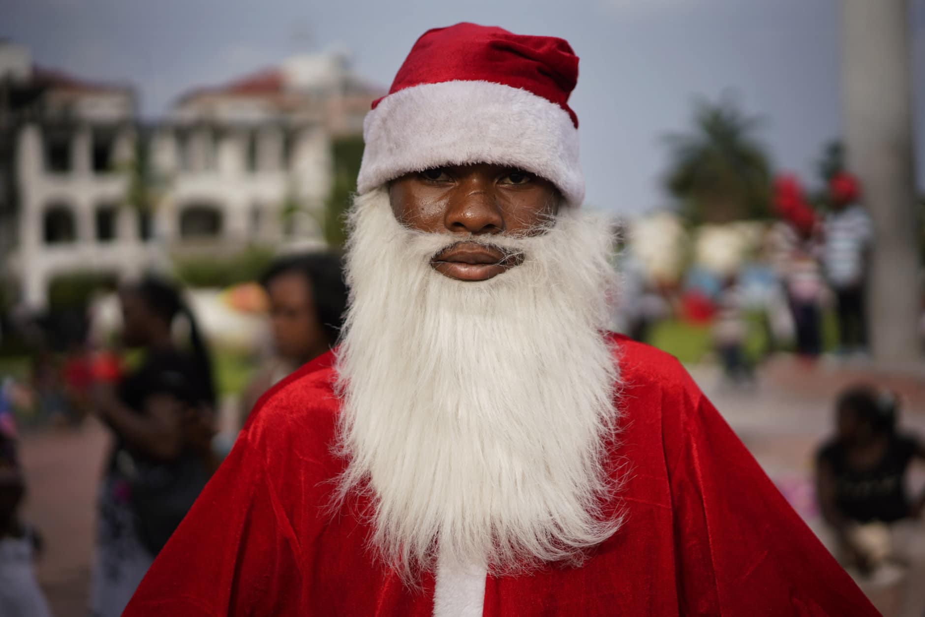 A Congolese Santa Claus waits to pose with children in Kinshasa, Congo, Tuesday Dec. 25, 2018. Traditionally Congolese dress up and take to the parks on Christmas day, this time five days before scheduled presidential and general elections. (AP Photo/Jerome Delay)