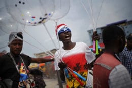 A Congolese man sells balloons in Kinshasa, Congo, Tuesday Dec. 25, 2018. Traditionally Congolese dress up and take to the parks on Christmas day, this time five days before scheduled presidential and general elections. (AP Photo/Jerome Delay)