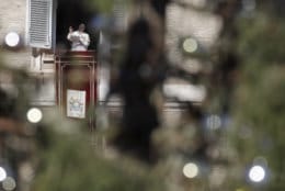 Framed by a Christmas tree, Pope Francis delivers his blessing during the Angelus noon prayer which he delivered from his studio window overlooking St. Peter's Square at the Vatican, Wednesday, Dec. 26, 2018. (AP Photo/Alessandra Tarantino)