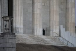 A lone U.S. Park Police officer stands watch at the Lincoln Memorial, Thursday, Dec. 27, 2018, in Washington, during a partial government shutdown. There is no end in sight to the partial government shutdown. President Donald Trump has vowed to hold the line on his budget demand, telling reporters during his visit to Iraq Wednesday that he'll do "whatever it takes" to get money for border security. The White House and congressional Democrats have been talking but to little effect. Washington area national parks will remain open during the partial government shutdown, but without visitor center services. (AP Photo/J. Scott Applewhite)