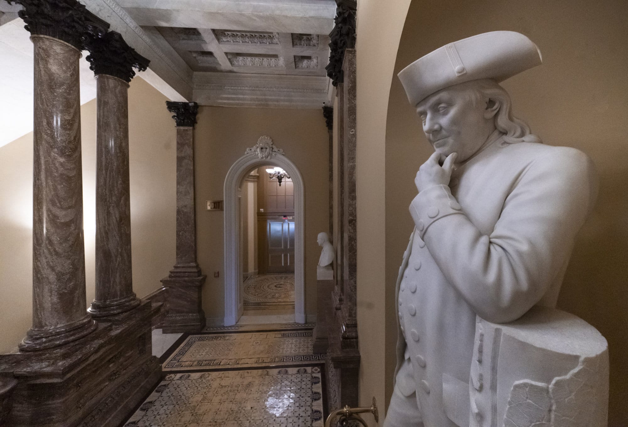 A statue of Benjamin Franklin is seen in an empty corridor outside the Senate at the Capitol in Washington, Thursday, Dec. 27, 2018, during a partial government shutdown. Chances look slim for ending the partial government shutdown any time soon. Lawmakers are away from Washington for the holidays and have been told they will get 24 hours' notice before having to return for a vote. (AP Photo/J. Scott Applewhite)
