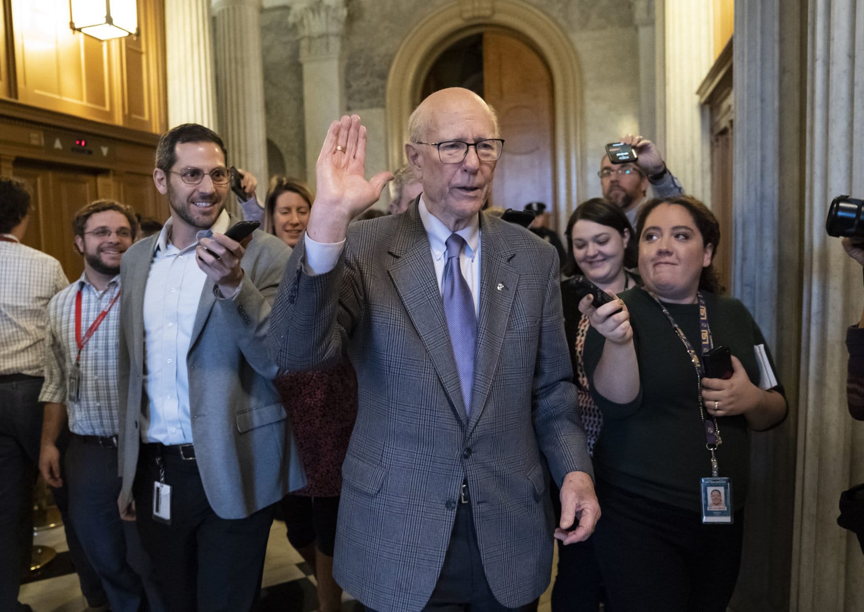 With reporters seeking comment, Republican Senator Pat Roberts of Kansas, chairman of the Senate Agriculture Committee, departs after he opened and closed a brief session of the U.S. Senate amid the partial government shutdown, at the Capitol in Washington, Thursday, Dec. 27, 2018. (AP Photo/J. Scott Applewhite)