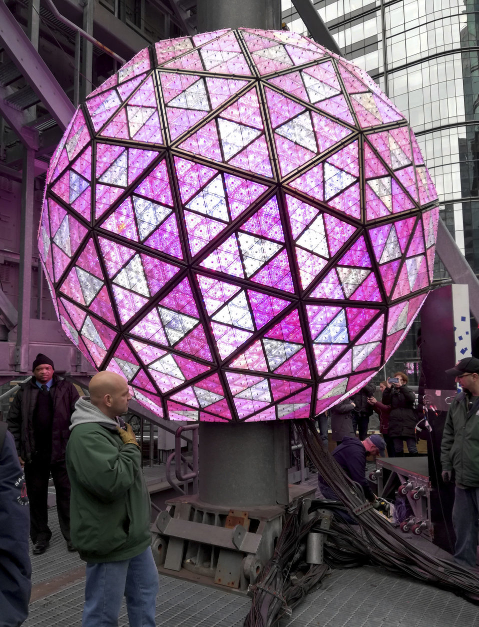 Workers in New York's Times Square perform a test on Sunday, Dec. 30, 2018, of the New Year's Eve ball that will be lit and sent up a 130-foot pole atop One Times Square to mark the start of the 2019 new year. Organizers of the annual event say the ball, illuminated by LEDs and enhanced by Waterford Crystal triangles, is capable of displaying a palette of more than 16 million vibrant colors and billions of patterns to create a spectacular kaleidoscope effect. (AP Photo/Julie Walker)