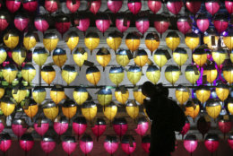 A woman prays in front of a wall of lanterns to celebrate the New Year at the Jogyesa Buddhist temple in Seoul, South Korea, Monday, Dec. 31, 2018. (AP Photo/Ahn Young-joon)