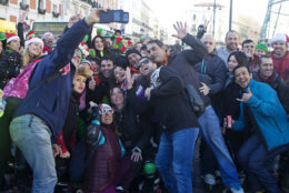 Revellers pose for a selfie during a New Year's Eve rehearsal celebration in Madrid, Spain, Monday, Dec. 31, 2018. (AP Photo/Paul White)