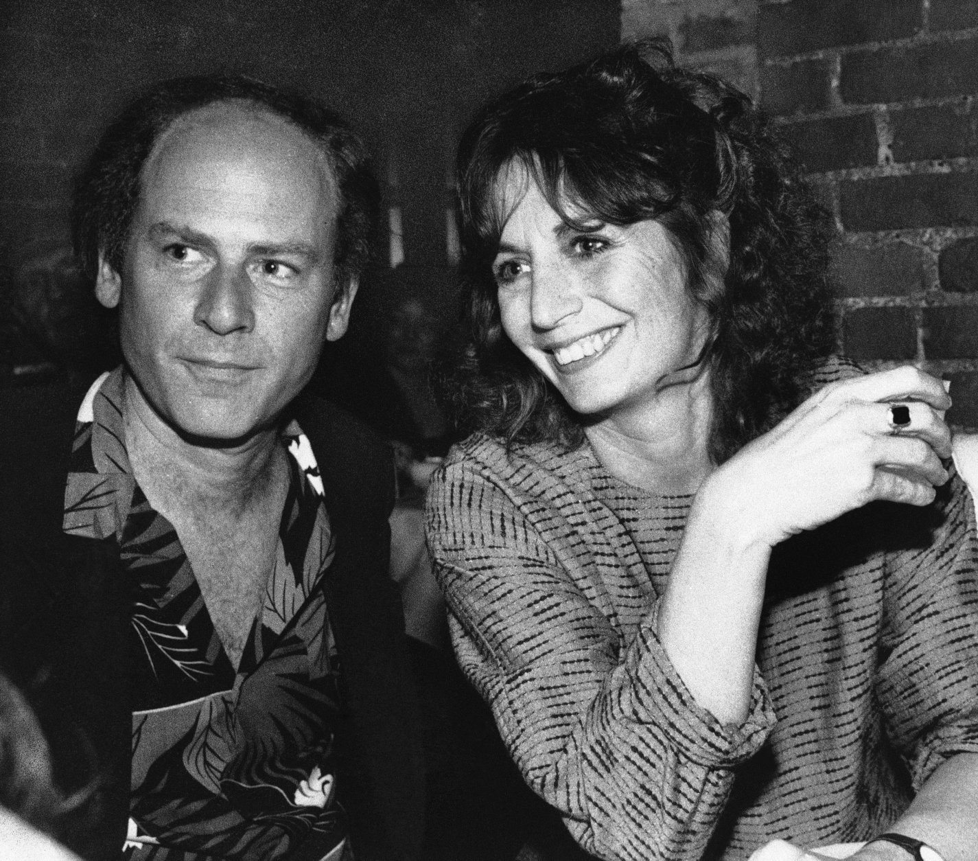 Penny Marshall relaxes with friend Art Garfunkel at an opening night party in a New York restaurant on Tuesday, May 14, 1985, following her performance in Eden Court at the Promenade Theater. (AP Photo/Frankie Ziths)