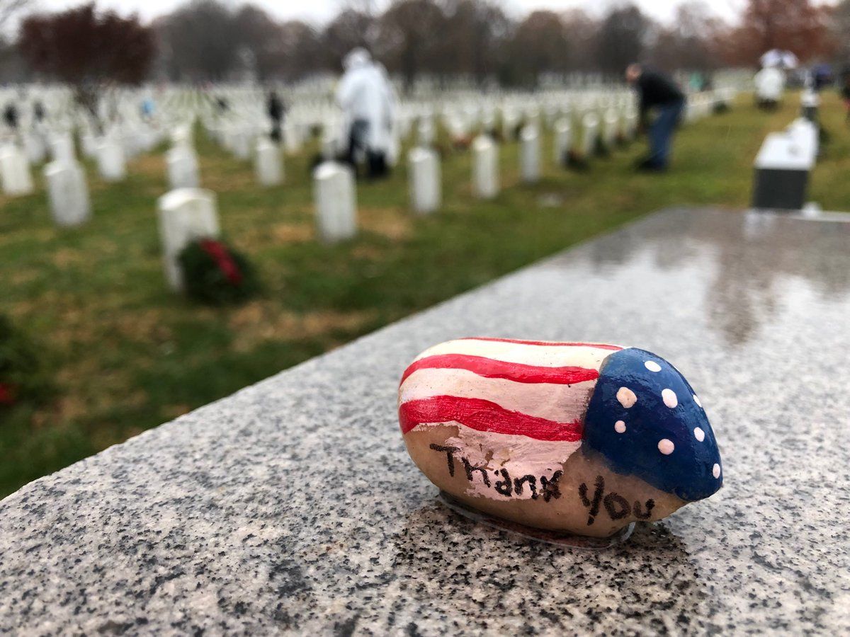 People lay tributes and wreaths at the Arlington National Cemetery. (WTOP/Kristi King) 