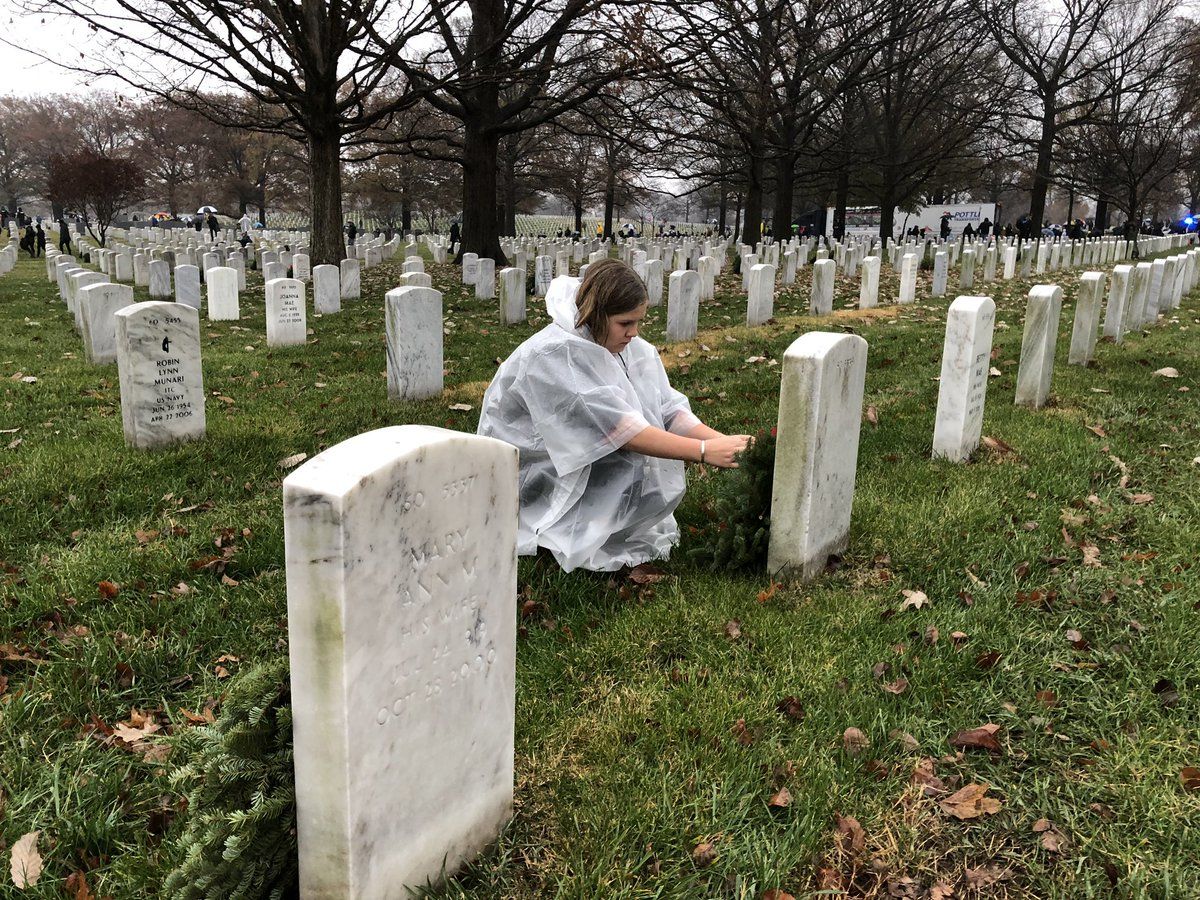 Volunteers braved the cold and rain to honor those who served. (WTOP/Kristi King)