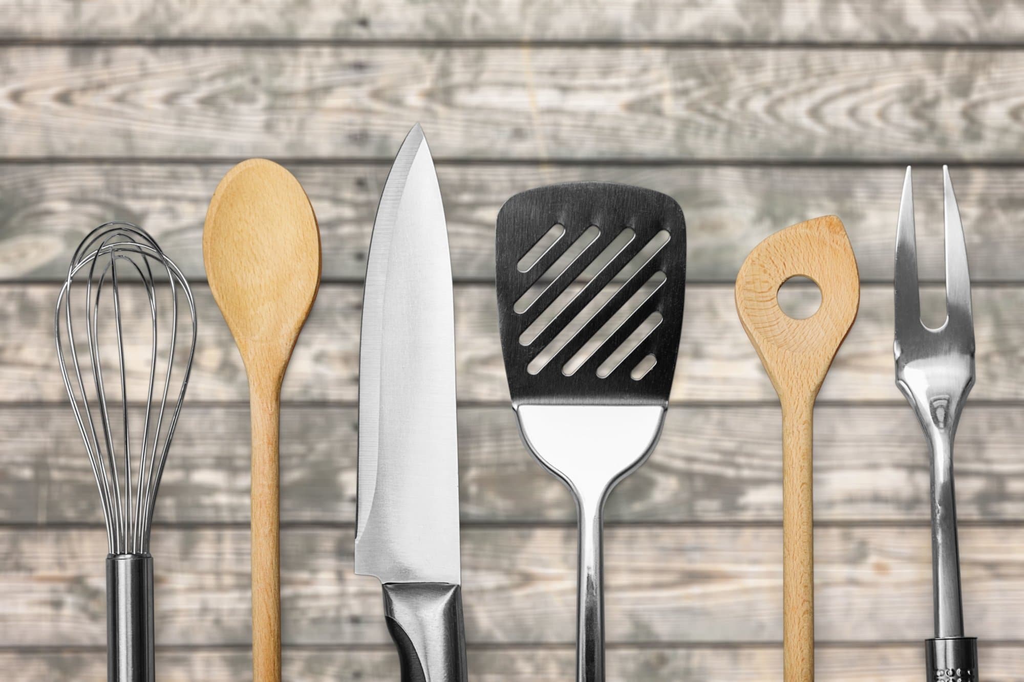 Kitchen metal and wooden utensil on  background