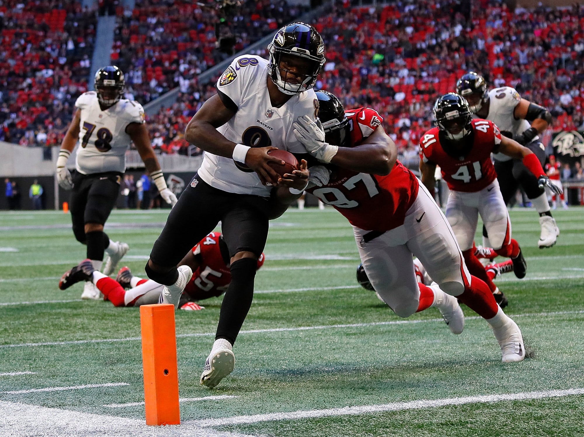 ATLANTA, GA - DECEMBER 02:  Lamar Jackson #8 of the Baltimore Ravens rushes for a touchdown past Grady Jarrett #97 of the Atlanta Falcons at Mercedes-Benz Stadium on December 2, 2018 in Atlanta, Georgia.  (Photo by Kevin C. Cox/Getty Images)