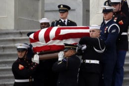WASHINGTON, DC - DECEMBER 05: (AFP OUT) A joint services military honor guard carries the flag-draped casket of former U.S. President George H. W. Bush from the U.S. Capitol to transport it to Washington National Cathedral December 5, 2018 in Washington, DC. President Bush will be buried at his final resting place at the George H.W. Bush Presidential Library at Texas A&amp;M University in College Station, Texas. A WWII combat veteran, Bush served as a member of Congress from Texas, ambassador to the United Nations, director of the CIA, vice president and 41st president of the United States.  (Photo by Alex Brandon - Pool/Getty Images)