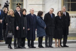 (L-R) Janna Ryan, Speaker of the House Paul Ryan, Transportation Secretary Elaine Chao, Senate Majority Leader Mitch McConnell, Iris Weinshall, Senate Minority Leader Chuck Schumer, House Minority Leader Nancy Pelosi and Paul Pelosi await the departure of the flag-draped casket of the late former President George H.W. Bush at the U.S. Capitol, December 5, 2018 in Washington, DC. A WWII combat veteran, Bush served as a member of Congress from Texas, ambassador to the United Nations, director of the CIA, vice president and 41st president of the United States. (Photo by Drew Angerer/Getty Images)