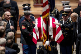 President Donald Trump's Chief of Staff John Kelly, left, watches as Former Sen. Alan Simpson, R-Wyo, right, touches the flag-draped casket of former President George H.W. Bush as it is carried out by a military honor guard during a State Funeral at the National Cathedral, December 5, 2018 in Washington, DC. President Bush will be buried at his final resting place at the George H.W. Bush Presidential Library at Texas A&amp;M University in College Station, Texas. A WWII combat veteran, Bush served as a member of Congress from Texas, ambassador to the United Nations, director of the CIA, vice president and 41st president of the United States. (Photo by Andrew Harnik-Pool/Getty Images)