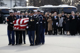 Former President George W. Bush, former first lady Laura Bush and other family members watch as the flag-draped casket of former President George H.W. Bush is carried by a joint services military honor guard to Special Air Mission 41 on December 5, 2018, at Joint Base Andrews, Maryland. (Photo by Alex Brandon - Pool/Getty Images)