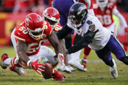 KANSAS CITY, MO - DECEMBER 09: Outside linebacker Justin Houston #50 of the Kansas City Chiefs strips the football from quarterback Lamar Jackson #8 of the Baltimore Ravens late in the fourth quarter at Arrowhead Stadium on December 9, 2018 in Kansas City, Missouri. The Chiefs won in overtime, 27-24. (Photo by David Eulitt/Getty Images)