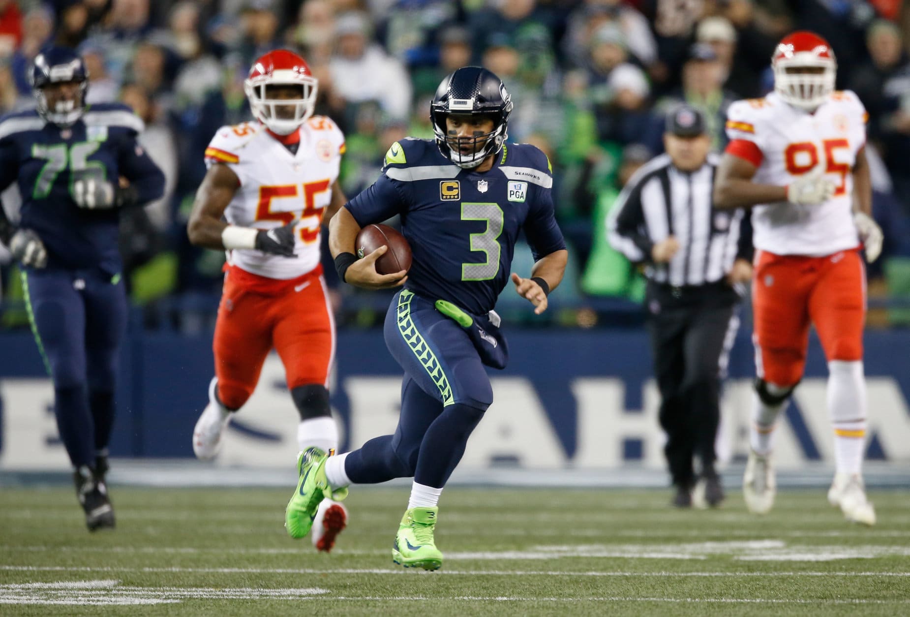 SEATTLE, WA - DECEMBER 23:  Quarterback Russell Wilson #3 of the Seattle Seahawks rushes for a first down during the first quarter of the game against the Kansas City Chiefs at CenturyLink Field on December 23, 2018 in Seattle, Washington.  (Photo by Otto Greule Jr/Getty Images)
