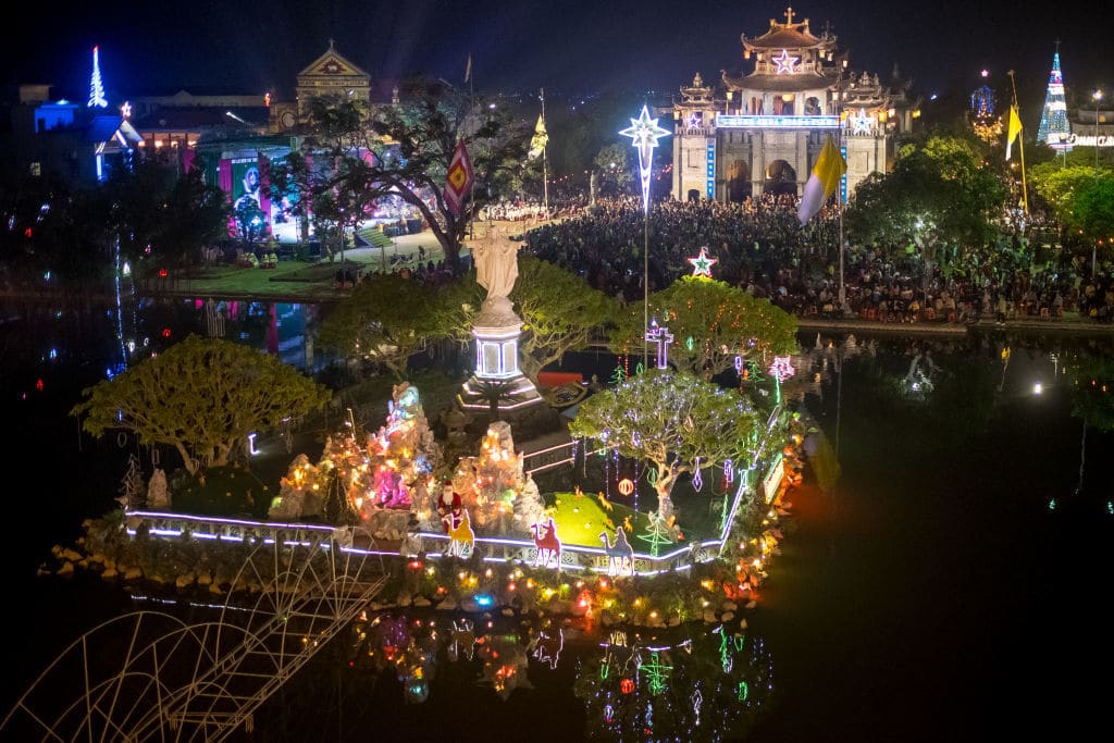 NINH BINH, VIETNAM - DECEMBER 24: Landscape of Phat Diem Cathedral on Christmas Eve on December 24, 2018 in Kim Son District, Ninh Binh Province, Vietnam. Phat Diem Cathedral, located about 120 kilometers from Hanoi to the south, in an area that has been a stronghold of Christianity in Vietnam since Portuguese missionaries began proselytizing Vietnam in the sixteenth century. This Catholic church was built in the 1875s to 1898s, with oriental architecture mixing Western architectural style and Vietnamese religious buildings. As a predominantly Buddhist nation, Christmas is not an official public holiday in Vietnam but many people have adopted to celebrate it both as a religious festival and a new cultural tradition.  (Photo by Linh Pham/Getty Images)