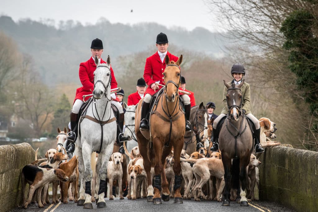 LACOCK, WILTSHIRE - DECEMBER 26: Joint Master and Huntsman, Stuart Radbourn (C) leads riders that have arrived for the Avon Vale Hunt's traditional Boxing Day meet in Lacock near Chippenham on December 26, 2018 in Wiltshire, England. Boxing Day is traditionally the biggest day in the hunt calendar, and despite the hunting ban that came into force in 2004, today is expected to see thousands of supporters drawn to meets across the country. (Photo by Matt Cardy/Getty Images)
