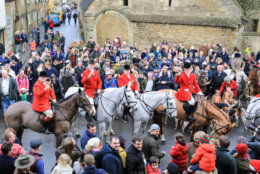 LACOCK, WILTSHIRE - DECEMBER 26: Hunt supporters  greet riders as the huntsman toast towards the camera, as they meet for the Avon Vale Hunt's traditional Boxing Day in Lacock near Chippenham on December 26, 2018 in Wiltshire, England. Boxing Day is traditionally the biggest day in the hunt calendar, and despite the hunting ban that came into force in 2004, today is expected to see thousands of supporters drawn to meets across the country. (Photo by Matt Cardy/Getty Images)