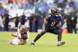 BALTIMORE, MARYLAND - DECEMBER 16: Quarterback Lamar Jackson #8 of the Baltimore Ravens runs in front of Gerald McCoy #93 of the Tampa Bay Buccaneers in the second half at M&amp;T Bank Stadium on December 16, 2018 in Baltimore, Maryland. (Photo by Rob Carr/Getty Images)
