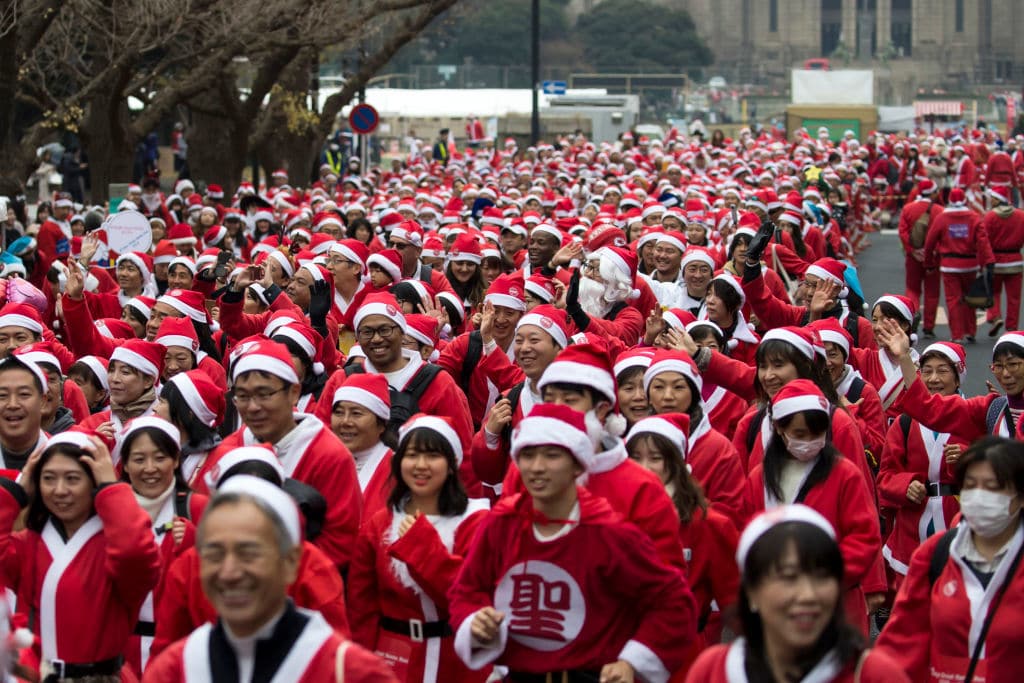 TOKYO, JAPAN - DECEMBER 23:  Participants wearing Santa Claus costumes take part in the Tokyo Great Santa Run 2018 on December 23, 2018 in Tokyo, Japan. About 5,000 people took part in the charity run event held in Tokyo for the first time where part of the participation fee goes into Christmas presents for children who have been hospitalized. (Photo by Tomohiro Ohsumi/Getty Images)