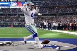 ARLINGTON, TEXAS - DECEMBER 23: Dak Prescott #4 of the Dallas Cowboys celebrates a touchdown in the first quarter of a football game against the Tampa Bay Buccaneers at AT&amp;T Stadium on December 23, 2018 in Arlington, Texas. (Photo by Tom Pennington/Getty Images)