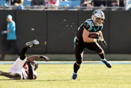 CHARLOTTE, NORTH CAROLINA - DECEMBER 23: Christian McCaffrey #22 of the Carolina Panthers runs the ball against Deion Jones #45 of the Atlanta Falcons in the first quarter during their game at Bank of America Stadium on December 23, 2018 in Charlotte, North Carolina. (Photo by Grant Halverson/Getty Images)