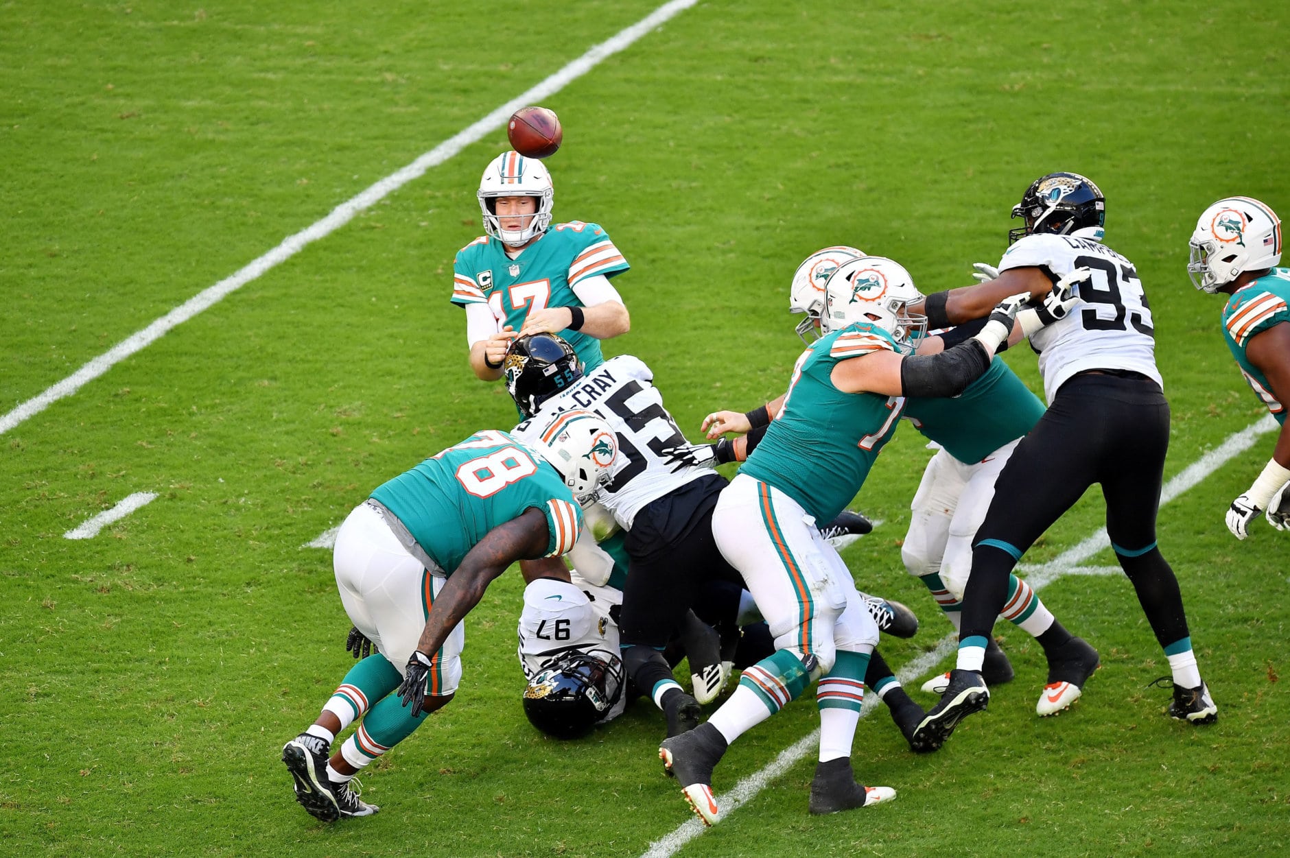 MIAMI, FLORIDA - DECEMBER 23:  Ryan Tannehill #17 of the Miami Dolphins passes under pressure by Lerentee McCray #55 of the Jacksonville Jaguars at Hard Rock Stadium on December 23, 2018 in Miami, Florida. (Photo by Mark Brown/Getty Images)