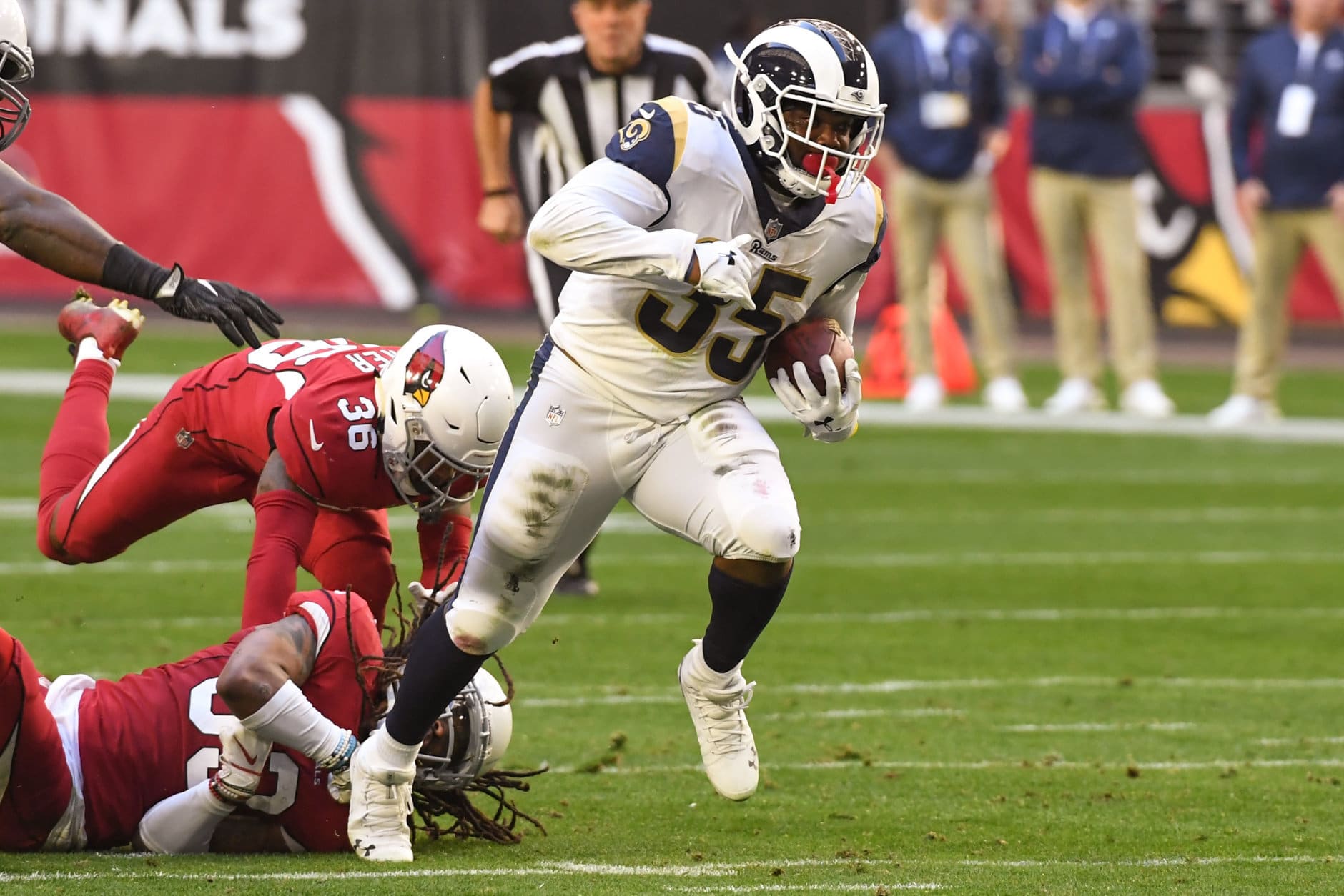 GLENDALE, ARIZONA - DECEMBER 23: C.J. Anderson #35 of the Los Angeles Rams carries against Tre Boston #33 and Budda Baker #36 of the Arizona Cardinals in the first half at State Farm Stadium on December 23, 2018 in Glendale, Arizona. (Photo by Norm Hall/Getty Images)