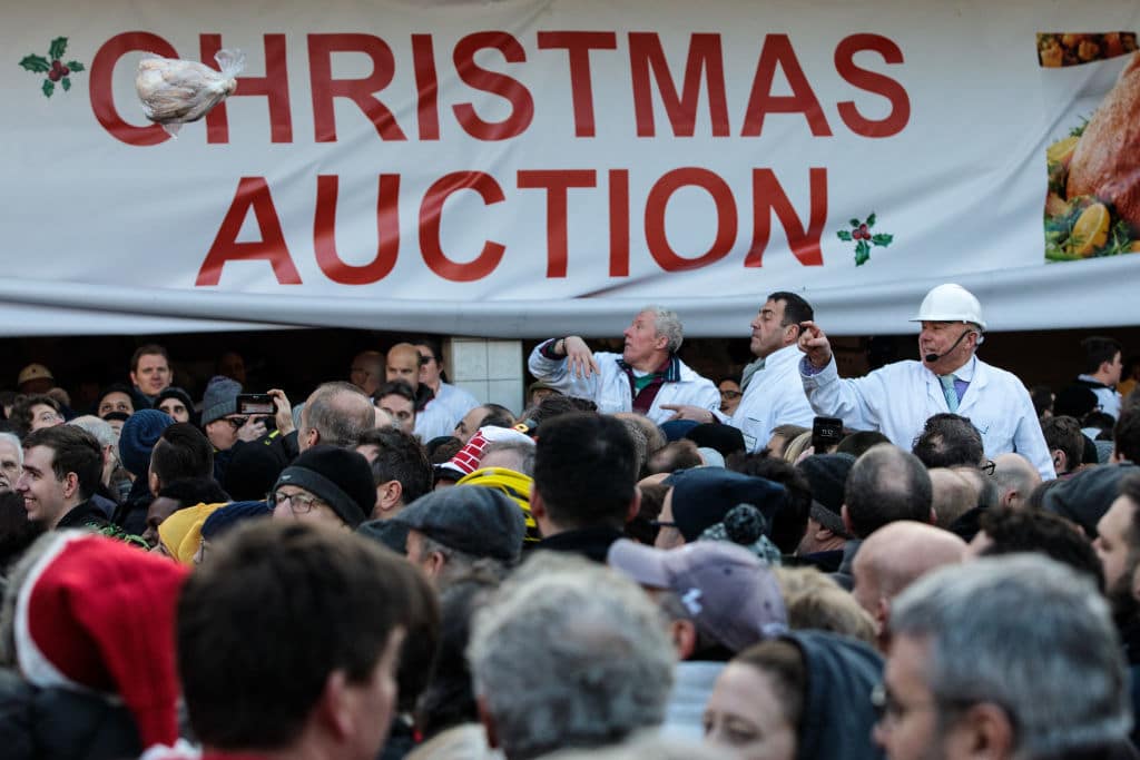 LONDON, ENGLAND - DECEMBER 24: Joints of meat are sold to customers during the annual Harts' Christmas Meat Auction at Smithfield Market on December 24, 2018 in London, England. The annual sell-off attracts hundreds of people to Smithfield Market, which this year celebrates its 150th anniversary, as they hope to snap up a bargain cut of meat including Turkey's, Pork, Beef and Lamb joints. (Photo by Jack Taylor/Getty Images)