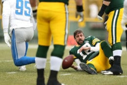 GREEN BAY, WISCONSIN - DECEMBER 30: Aaron Rodgers #12 of the Green Bay Packers lays on the ground after being sacked by Romeo Okwara #95 of the Detroit Lions during the first half of a game at Lambeau Field on December 30, 2018 in Green Bay, Wisconsin. (Photo by Dylan Buell/Getty Images)