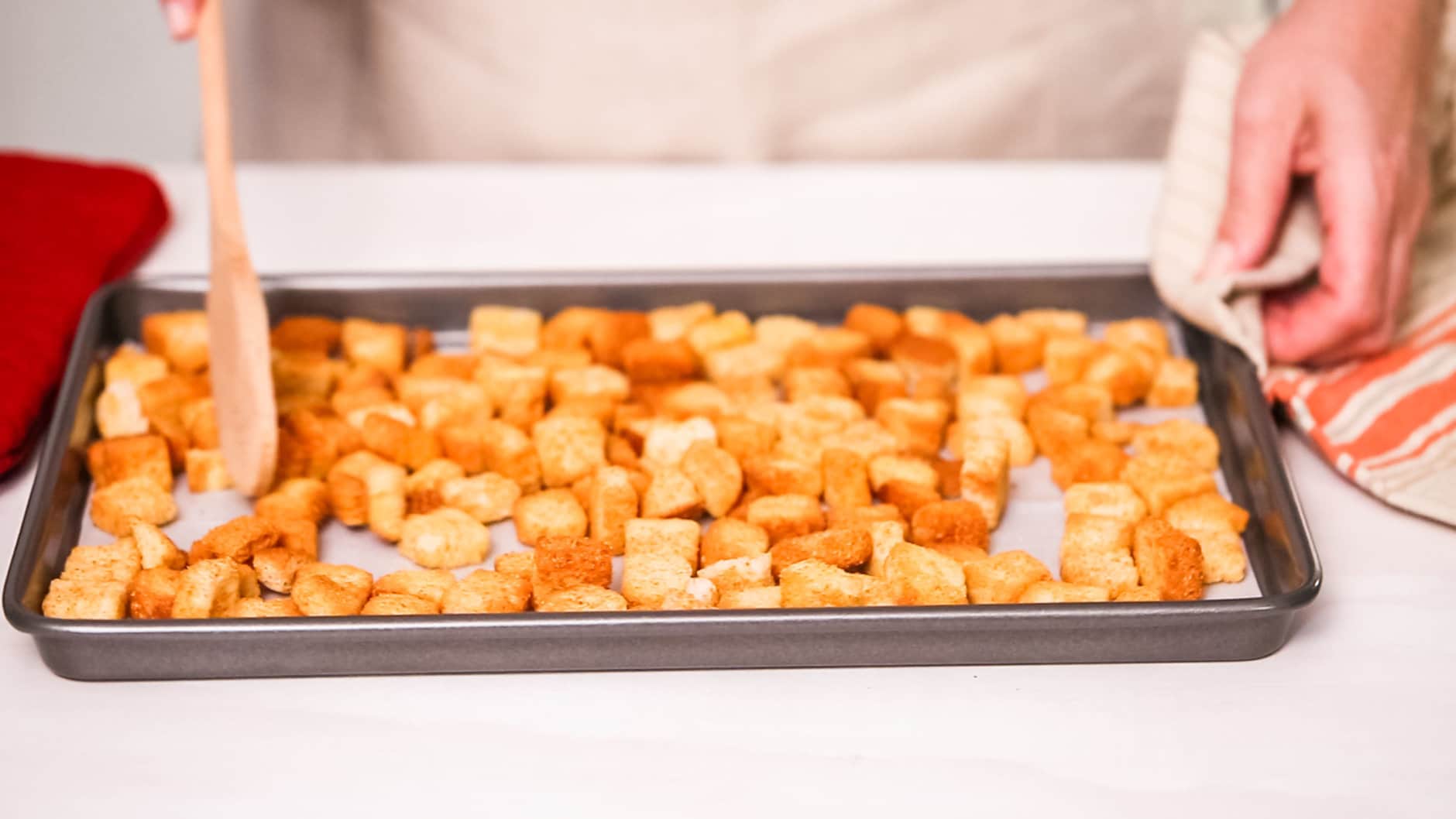 Fresh french toast croutons on baking sheet.