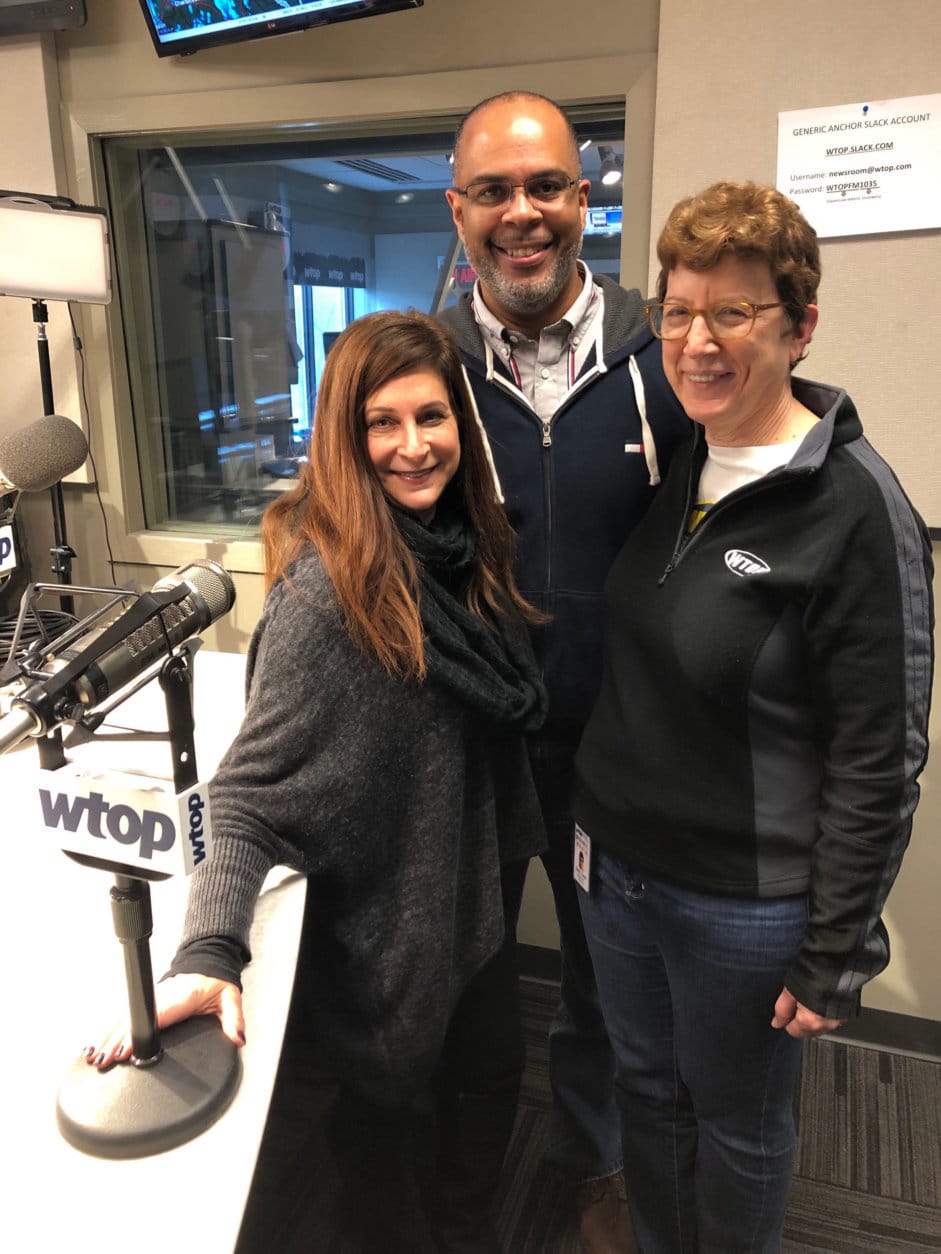 WTOP midday anchors Debra Feinstein and Mark Lewis with editor Judy Taub on Taub's last day, Dec. 21, 2018. (WTOP/Julia Ziegler)