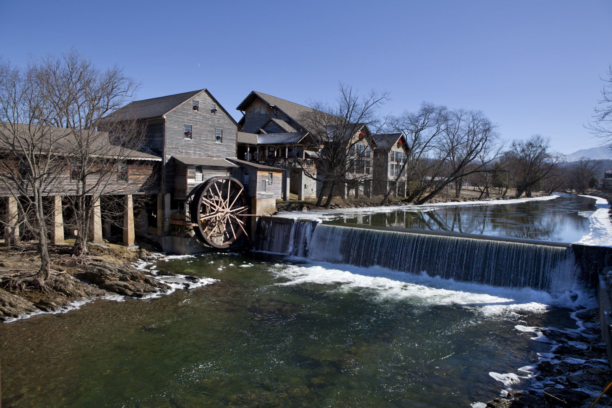 Watermill on the Little Pigeon river, in the mountain community of Pigeon Forge, Tennessee during the winter. Ice can be seen along the banks of the river