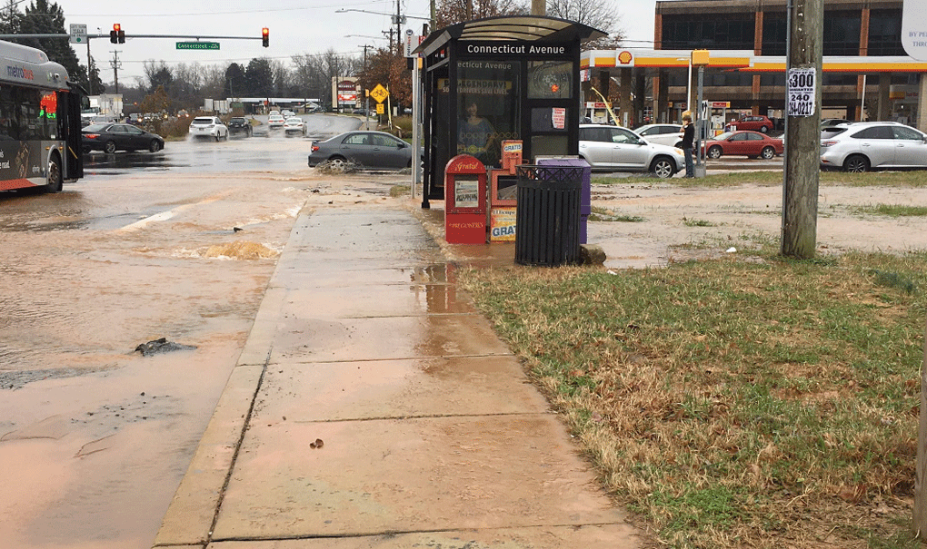 A water main break causes water to gush onto the street in Silver Spring on Sunday, Dec. 2, 2018. (WTOP/Liz Anderson) 