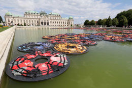 The installation 'F Lotus ' of Chinese artist Ai Weiwei for the exhibition 'translocation- transformation' made of life vests is swimming in the pond at the Upper Belvedere palace in Vienna, Austria, Wednesday, July 13, 2016. (AP Photo/Ronald Zak)