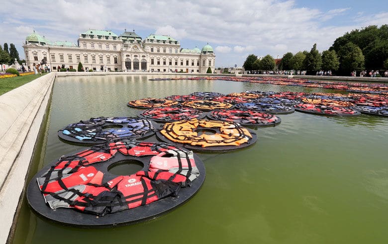 The installation 'F Lotus ' of Chinese artist Ai Weiwei for the exhibition 'translocation- transformation' made of life vests is swimming in the pond at the Upper Belvedere palace in Vienna, Austria, Wednesday, July 13, 2016. (AP Photo/Ronald Zak)