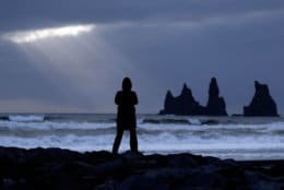 A woman stands on the black beach in Vik, Iceland, near the Volcano Katla, Friday, Oct. 28, 2016. (AP Photo/Frank Augstein)
