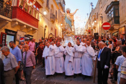 In this photo taken on Wednesday, Aug. 15, 2018, devotees carry a statue of the Virgin Mary through the streets of Rabat on the island of Gozo in the Maltese archipelago, during the feast day of the Assumption of Mary. The streets and quaint lanes of Rabat come to life during the annual religious feast day of the Assumption of Mary. The holiday is the peak of the summer season of religious village feasts and is celebrated in seven towns and villages, including Rabat. (AP Photo/Niranjan Shrestha)